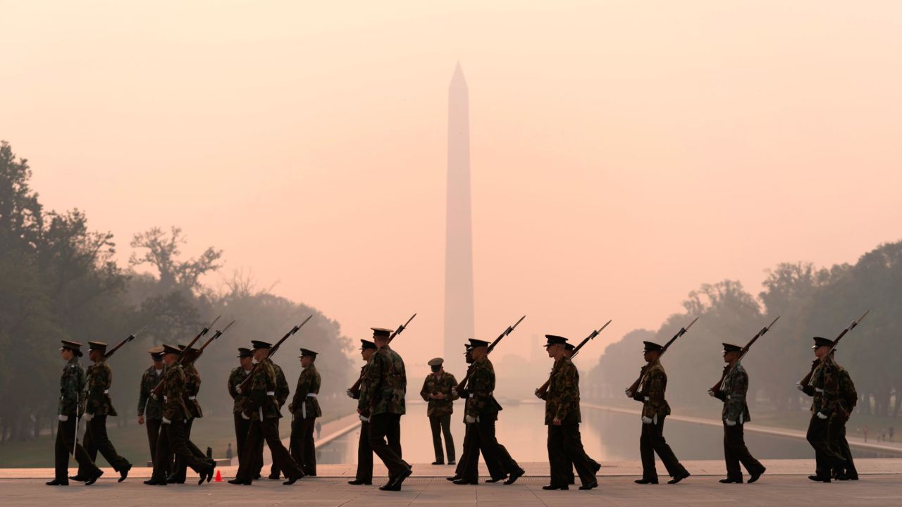 With the Washington Monument in the background under a thick layer of smoke, a Marine Corps honor color guard rehearses on Thursday.
