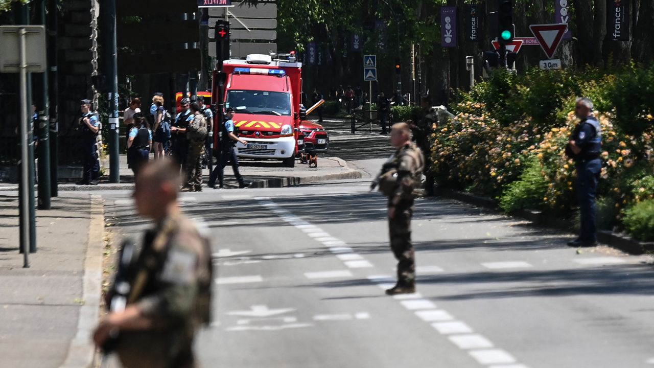 French police officers stand near the scane of the attack in Annecy, southeastern France on June 8, 2023.
