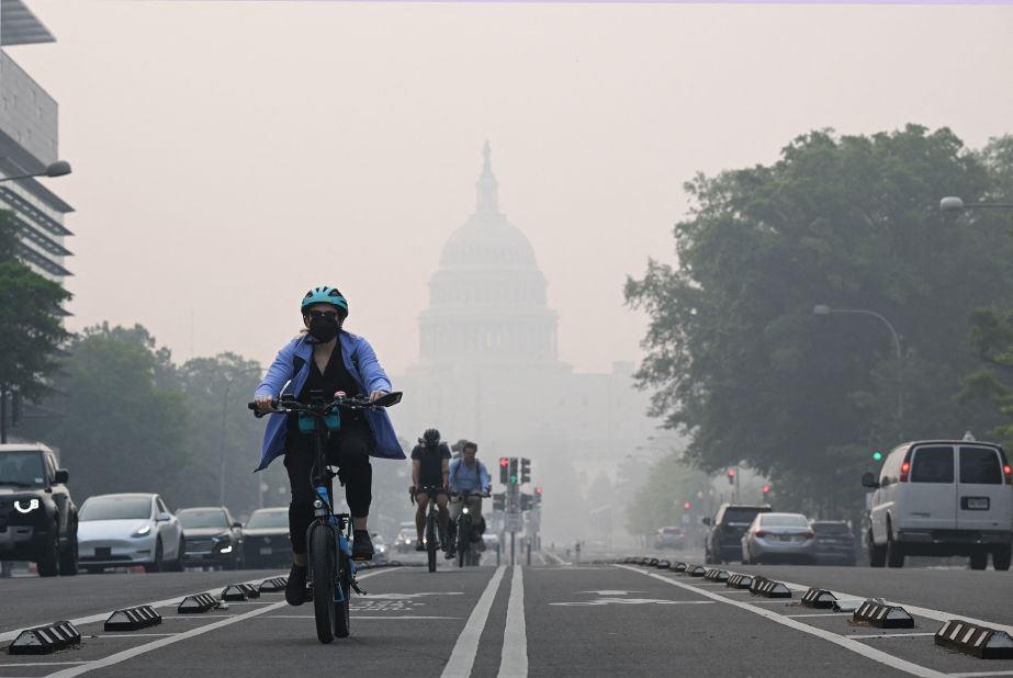 A cyclist rides under a blanket of haze that was partially obscuring the US Capitol on June 8.