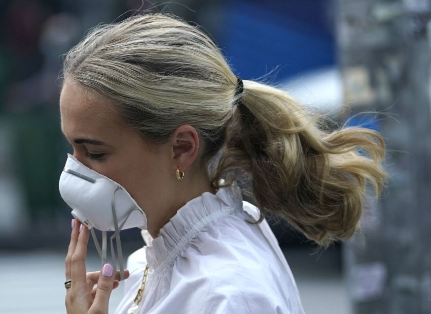 A woman in New York City wears a mask during the morning rush hour on June 8. The city saw slight air quality improvements, but levels were still considered "very unhealthy" for residents.