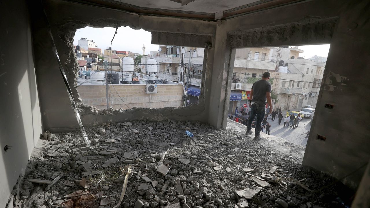 Palestinians inspect the site where Israeli forces demolished the house of Islam Faroukh, who was accused of carrying out two bombings in November.