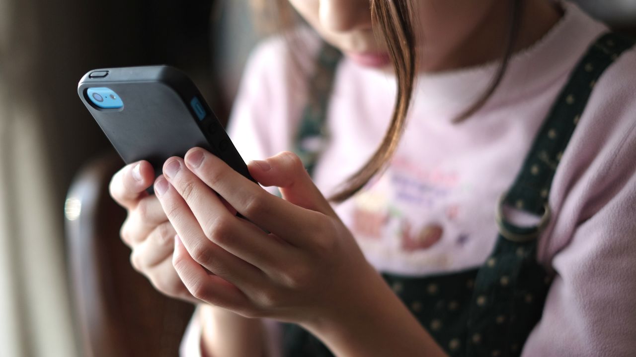 A child holds a smartphone 