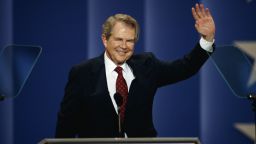 Pat Robertson waves from a podium in 1992.