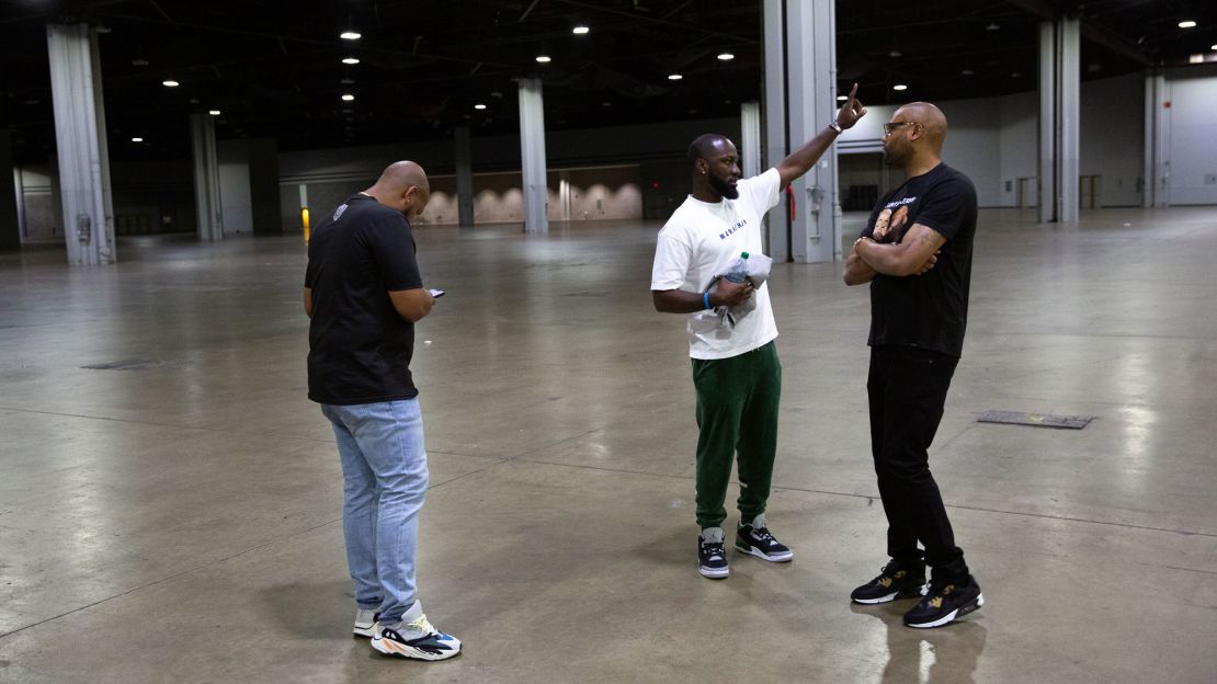 Troy Millings, left, Earn Your Leisure Chief Operations Manager Abdoulaye Sow, center, and Rashad Bilal, tour an area at the Georgia World Congress Center in Atlanta on June 2, 2023. Millings and Bilal's platform "Earn Your Leisure" is planning an event there.