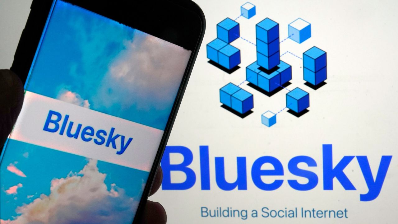 The Bluesky app is seen on a phone and laptop in June 2023.