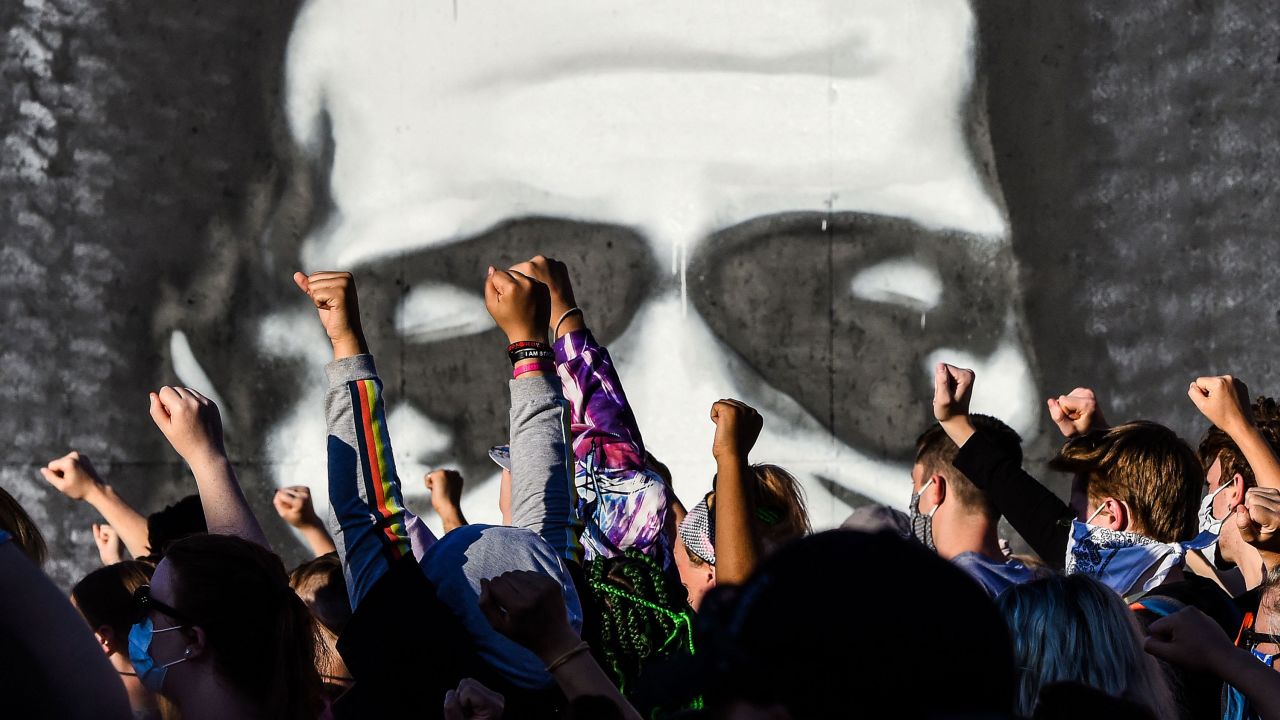 People raise their fists in June 2020 as they protest the police killing of George Floyd.