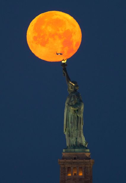 The last full moon of the spring, aka the <a href="https://www.cnn.com/2023/06/03/world/june-full-moon-strawberry-moon-scn/index.html" target="_blank">strawberry moon</a>, is seen behind the Statue of Liberty in New York on Sunday, June 4.