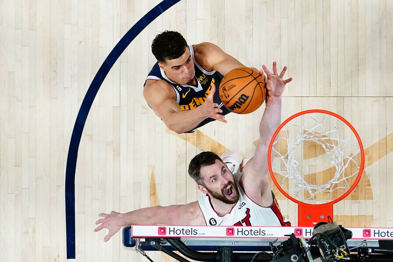 Miami Heat forward Kevin Love, bottom, and Denver Nuggets forward Michael Porter Jr. reach for a rebound during Game 2 of the NBA Finals on Sunday, June 4. Miami won the game to tie the best-of-seven series at 1-1.