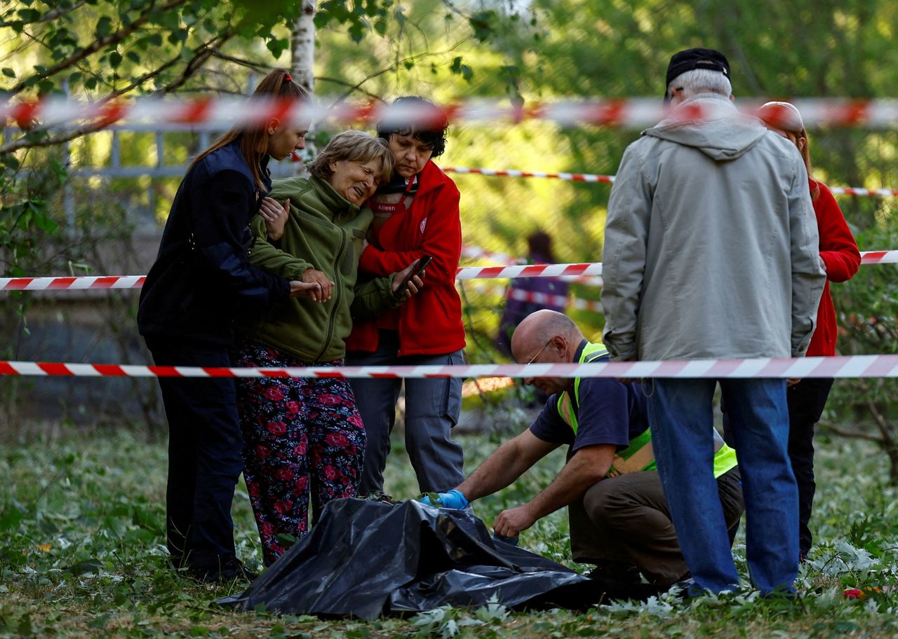 A woman in Kyiv, Ukraine, reacts as she looks at the body of her daughter who was killed during a Russian missile strike on Thursday, June 1. Three people, including a young girl, <a href=