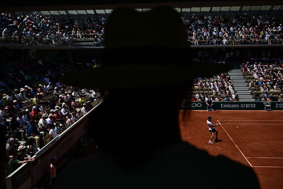 A tennis fan watches Thiago Seyboth Wild play a forehand during a French Open singles match in Paris on Saturday, June 3.