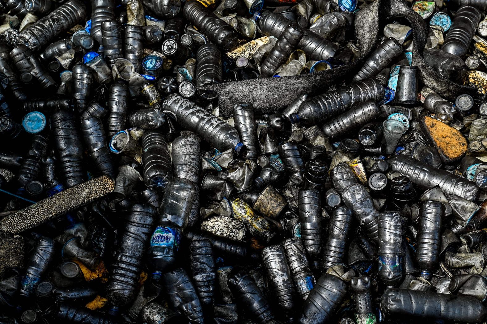 Oil-covered garbage and plastic waste sit on the water's surface at a port in Banda Aceh, Indonesia, on Monday, June 5.