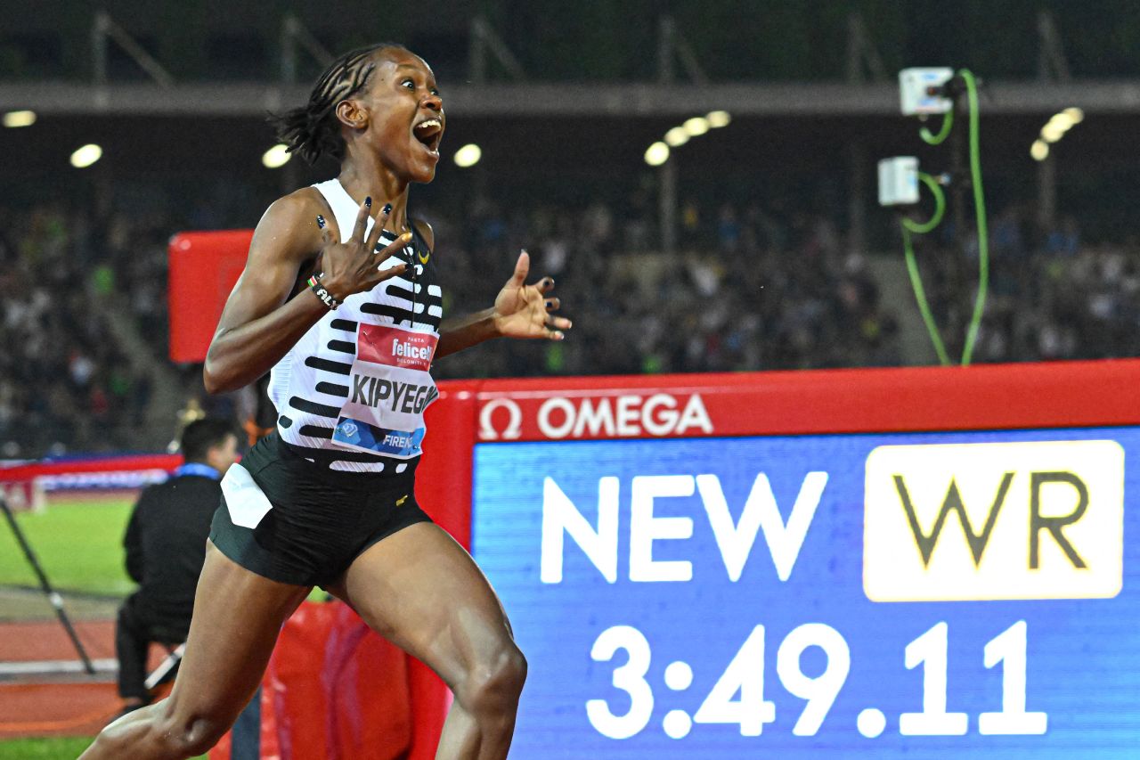 Kenya's Faith Kipyegon reacts as she wins the 1,500 meters and <a href=
