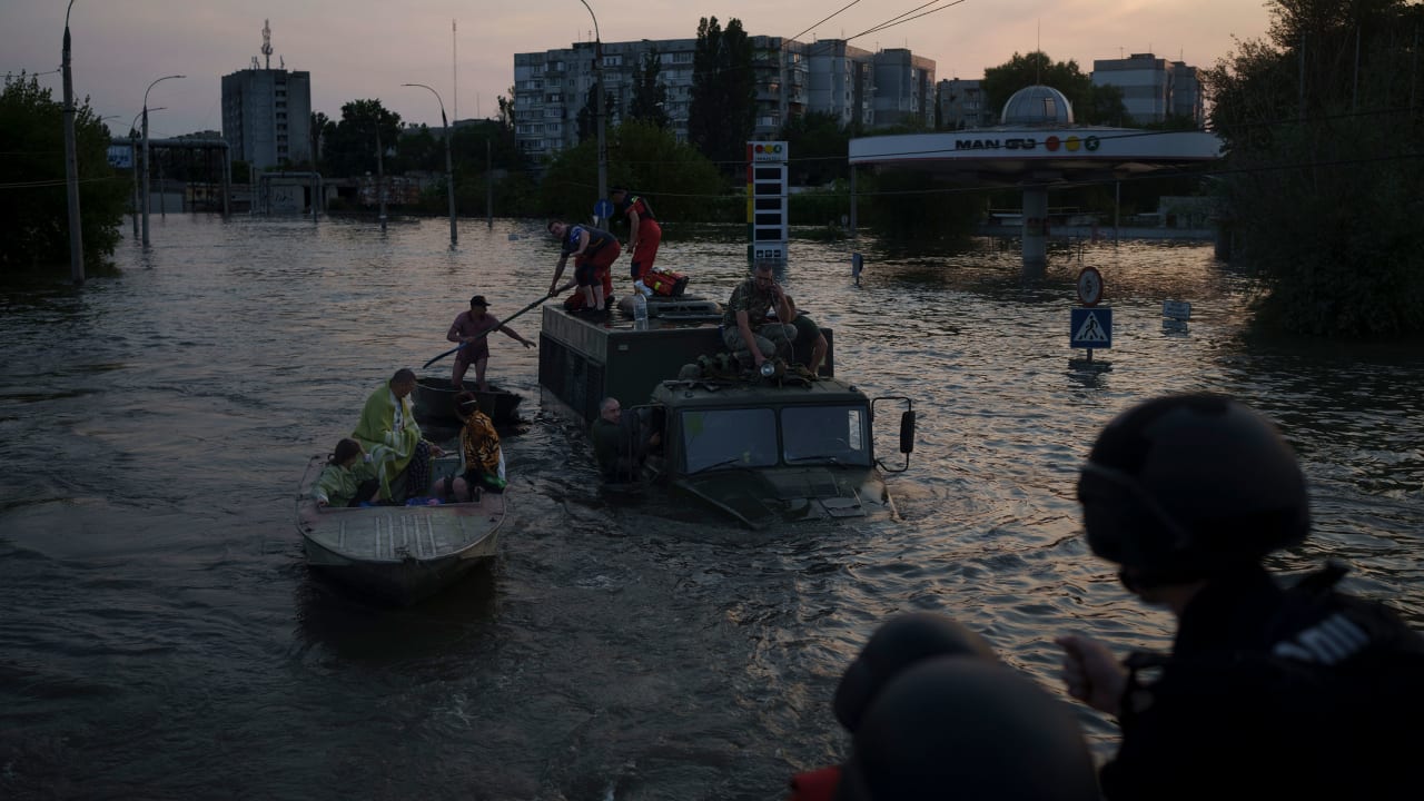 Residents are evacuated from a flooded neighborhood in Kherson, Ukraine, Tuesday, June 6, 2023. A major dam in southern Ukraine has collapsed, flooding villages, endangering crops in the country's breadbasket and threatening drinking water supplies. (AP Photo/Felipe Dana)