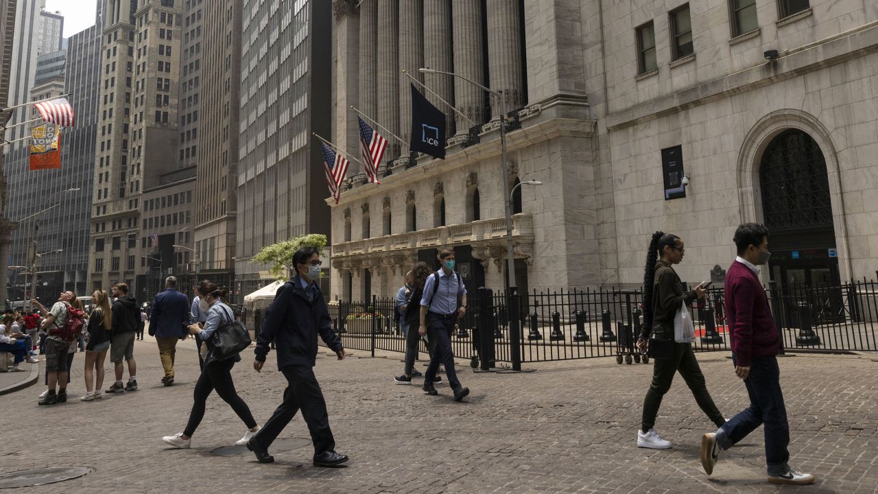 Pedestrians wear protective masks due to poor air quality from wildfires in Canada outside the New York Stock Exchange in New York, US, on Thursday, June 8, 2023. The US Northeast will continue to breathe in choking smoke from fires across eastern Canada for the next few days, raising health alarms across impacted areas. Photographer: Angus Mordant/Bloomberg via Getty Images