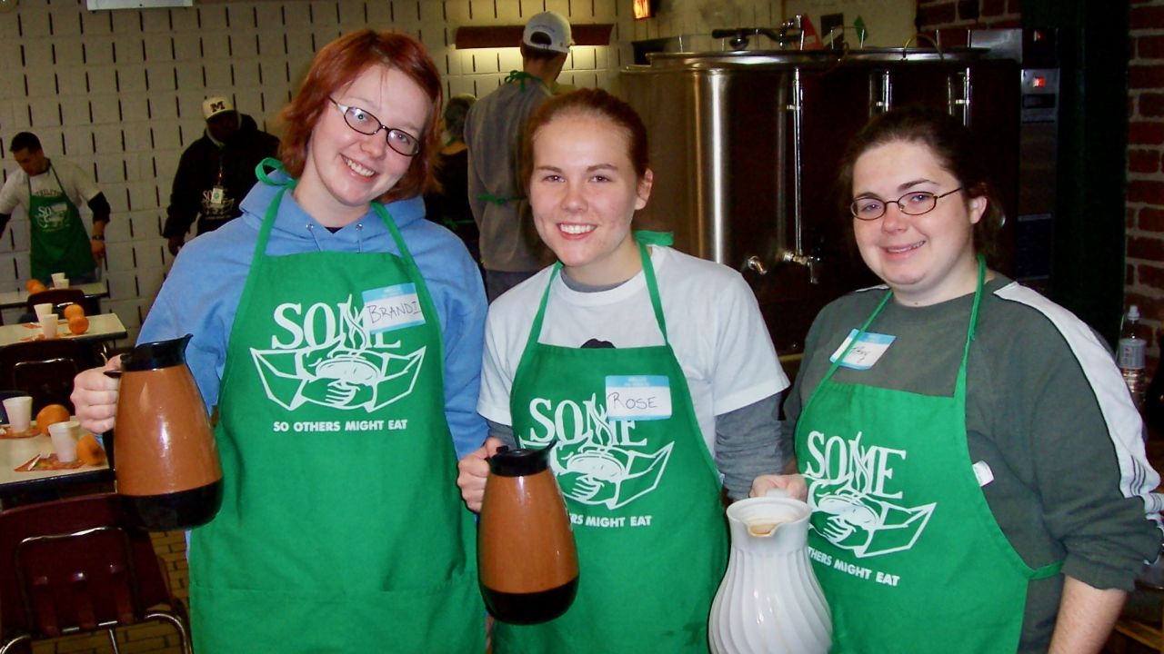 Brandi Tuck, left, as a college junior, volunteering at a homeless shelter on spring break