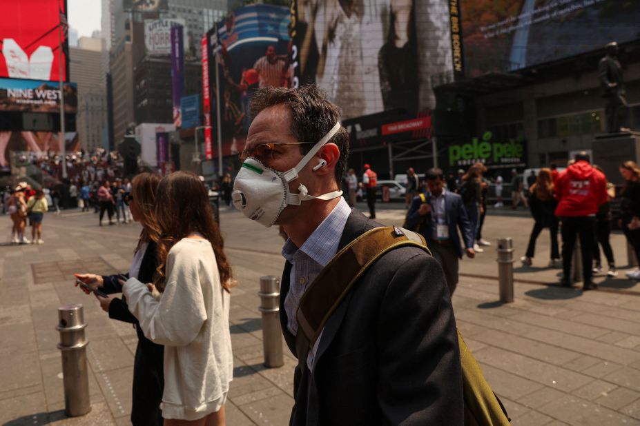 A man wears a protective face mask while walking through Times Square in New York on June 8.