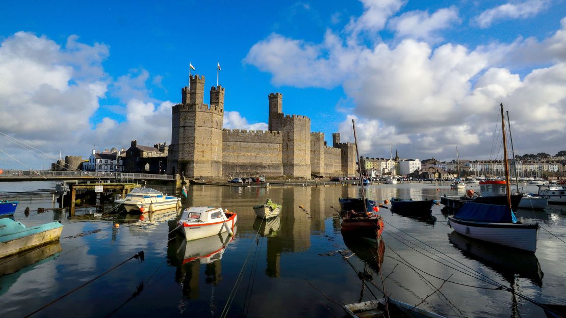 The dramatic Caernarfon Castle is a royal fortress-palace on the banks of the River Seiont in Wales. 