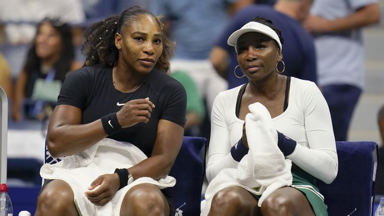 Serena Williams, left, and Venus Williams, of the United States, sit together during their first-round doubles match against Lucie Hradecká and Linda Nosková, of the Czech Republic, at the U.S. Open tennis championships, Thursday, Sept. 1, 2022, in New York. (AP Photo/Charles Krupa)