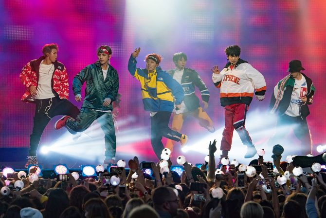 BTS sport colorful streetwear to perform on "Jimmy Kimmel Live" in November 2017. 