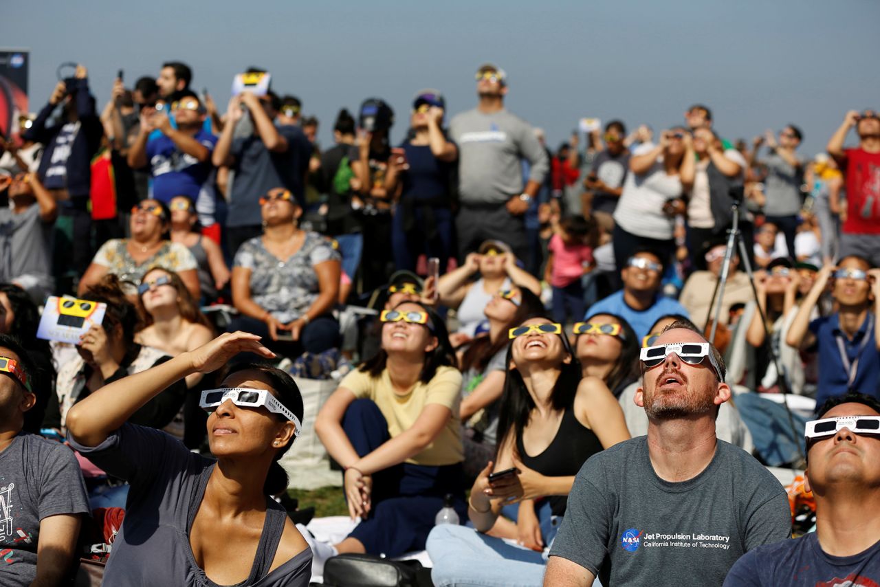 People watch the solar eclipse on the lawn of Griffith Observatory in Los Angeles, California, U.S., August 21, 2017. Location coordinates for this image are 34°7'9"N 118°18'1"W.  REUTERS/Mario Anzuoni