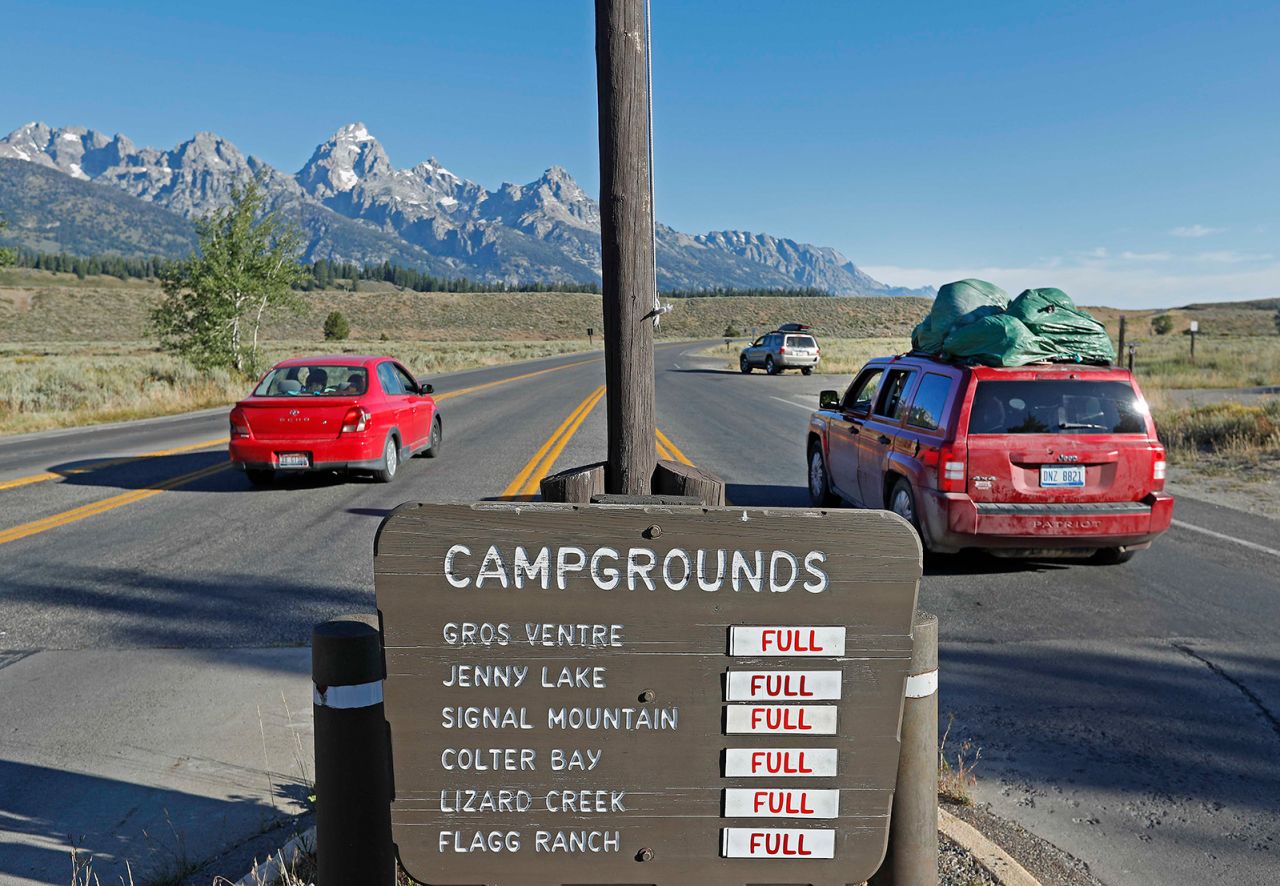 JACKSON, WY - AUGUST 19: With a sign showing full camp grounds, cars drive into Grand Teton National Park on August 19, 2017 outside Jackson, Wyoming. People are flocking to the Jackson and Teton National Park area for the 2017 solar eclipse which will be one of the areas that will experience a 100% eclipse on Monday August 21, 2017.  (Photo by George Frey/Getty Images)