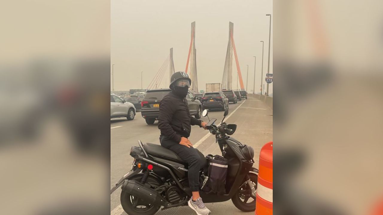 Uber Eats driver William Medina travels from Queens to Brooklyn through smoke from Canadian Wildfires on Wednesday, June 7. 