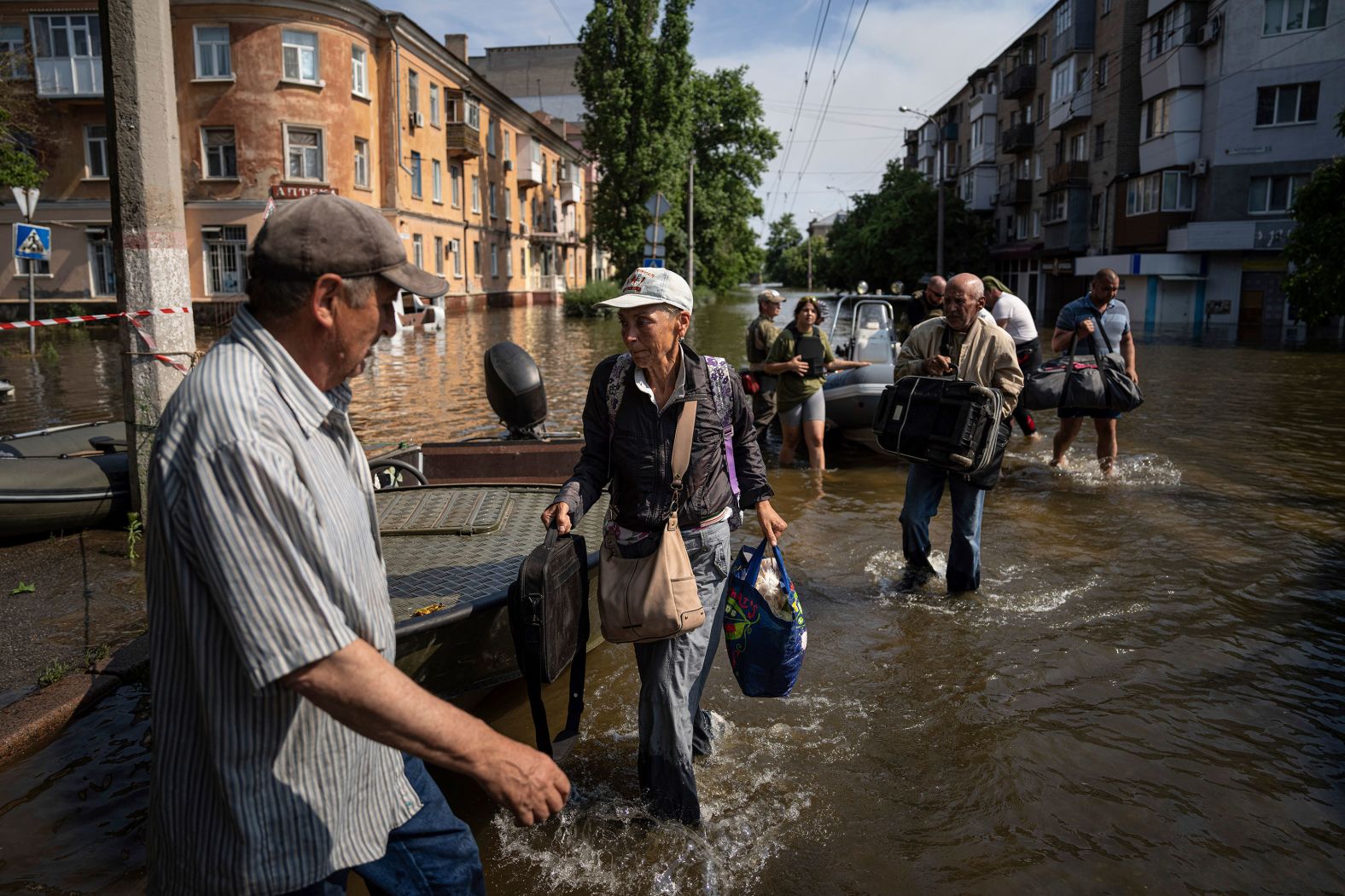 Alyona Shkrygalova evacuates from a flooded neighborhood in Kherson on Friday, June 9.