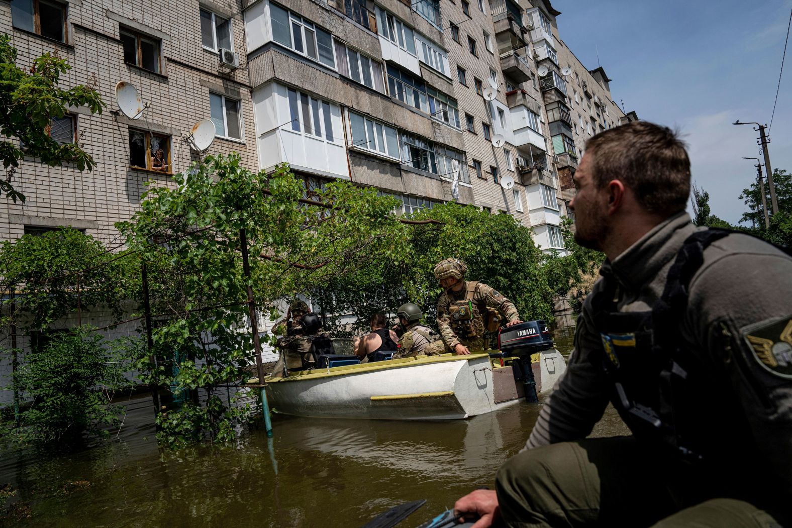 Ukrainian servicemen use boats to evacuate people in a flooded neighborhood of Kherson on June 8.