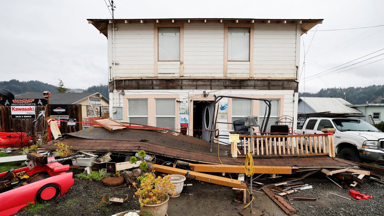 A Rio Dell resident inspects the collapsed second-story porch of his house after the quake on December 20.
