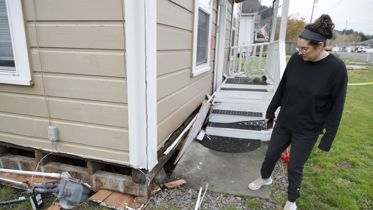 Jacqui McIntosh inspects damage at her red-tagged home in Rio Dell on December 21, 2022.