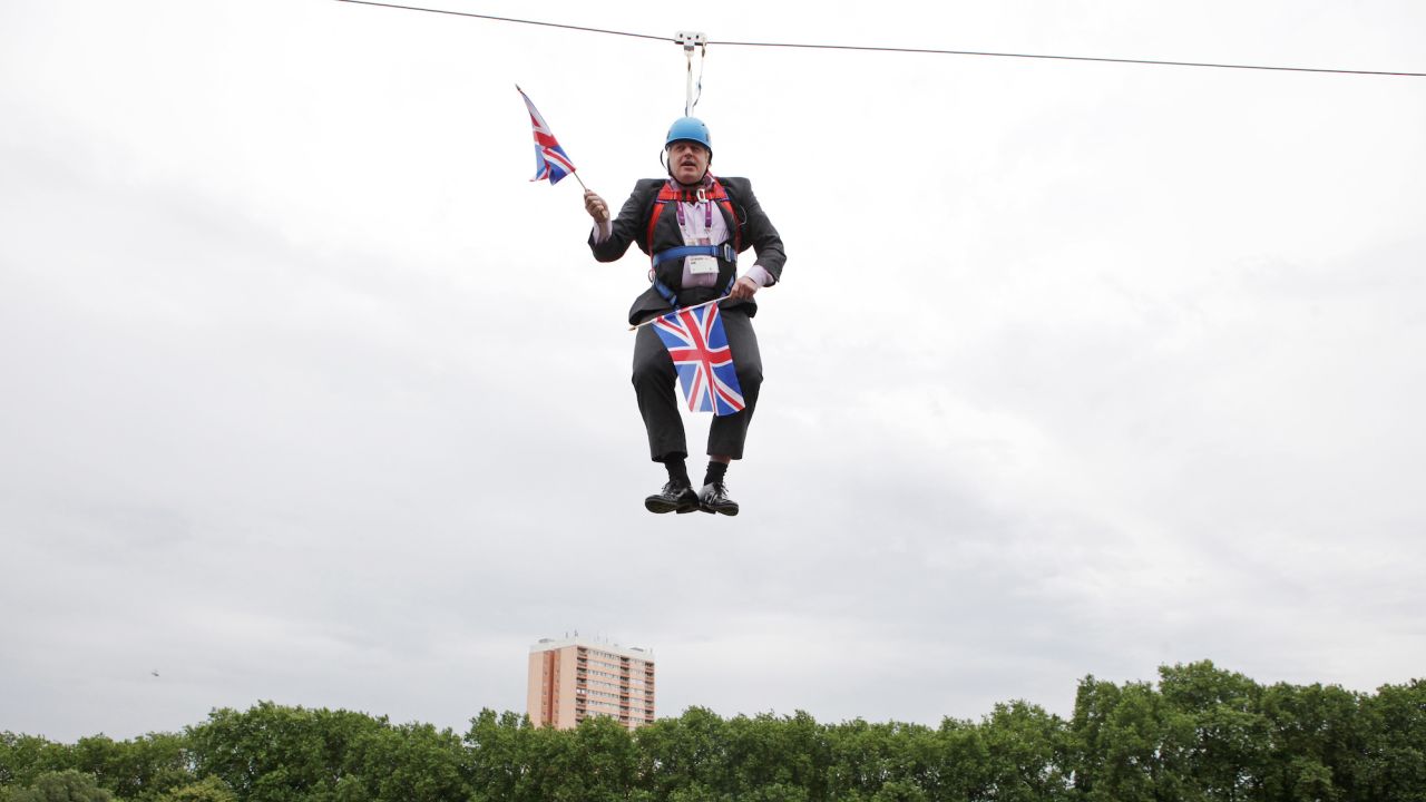 Boris Johnson gets stuck on a zip-line in Victoria Park in London where the 2012 Olympic Games were being shown on a big screen on August 1, 2012.