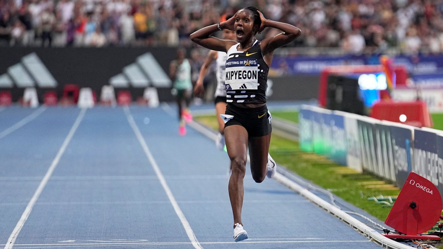 Faith Kipyegon, of Kenya, crosses the finish line to win the Women 5000 meters setting a new world record during the Meeting de Paris Diamond League athletics meet in Paris, Friday, June 9, 2023.