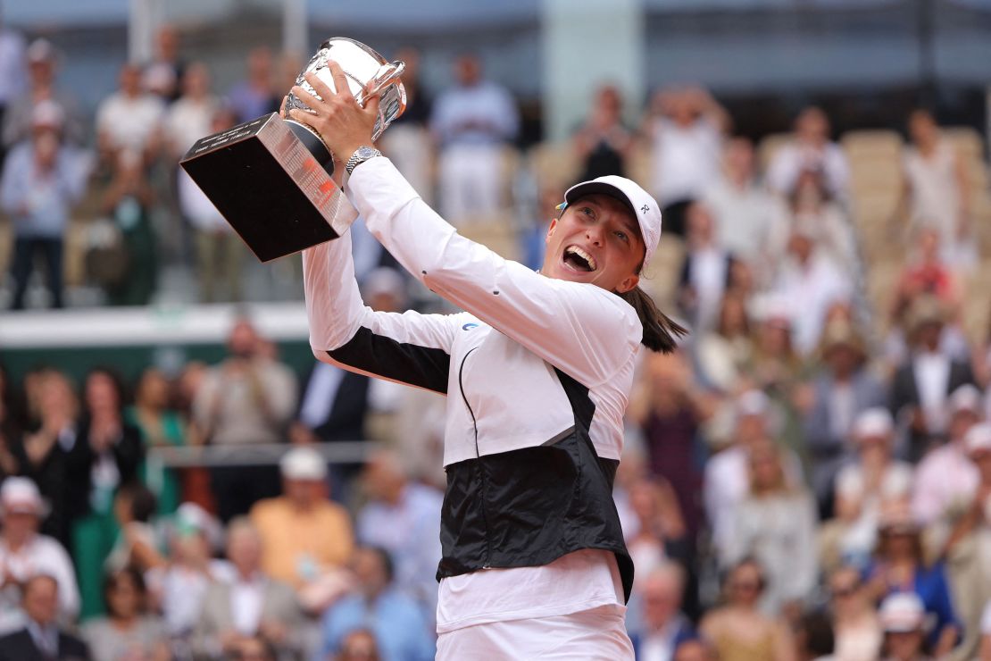 Poland's Iga Swiatek raises the trophy Suzanne Lenglen following her victory over Czech Republic's Karolina Muchova during their women's singles final match on day fourteen of the Roland-Garros Open tennis tournament at the Court Philippe-Chatrier in Paris on June 10, 2023. 