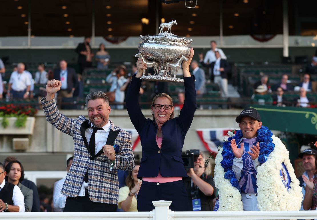 Trainer Jena Antonucci holds the winner's trophy with owner Jon Ebbert and Jockey Javier Castellano, who rode Arcangelo to victory at the 155th Belmont Stakes.