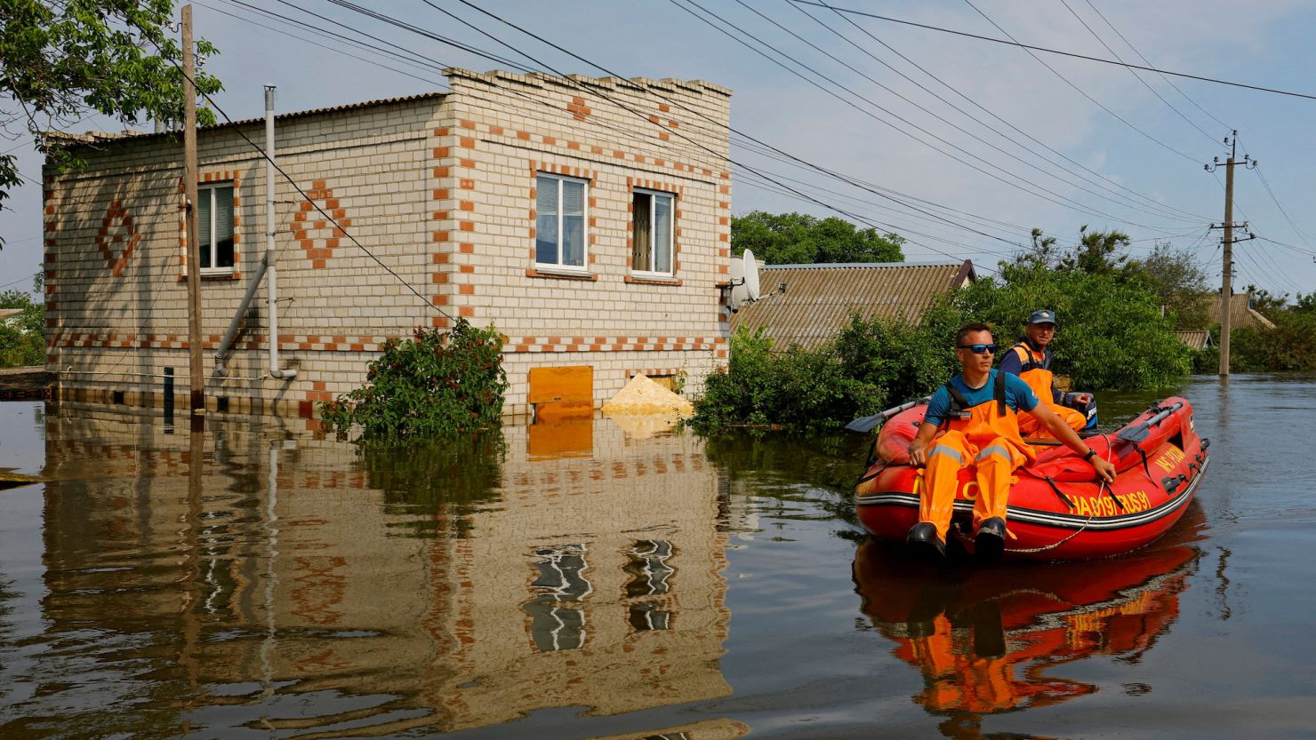 Members of Russia's emergencies ministry use an inflatable boat in a flooded area following the collapse of the Kakhovka dam on June 8.