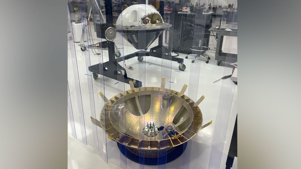 Varda's capsule, a test article of which is shown in the rear of this image, is set to launch on a SpaceX rocket June 12.