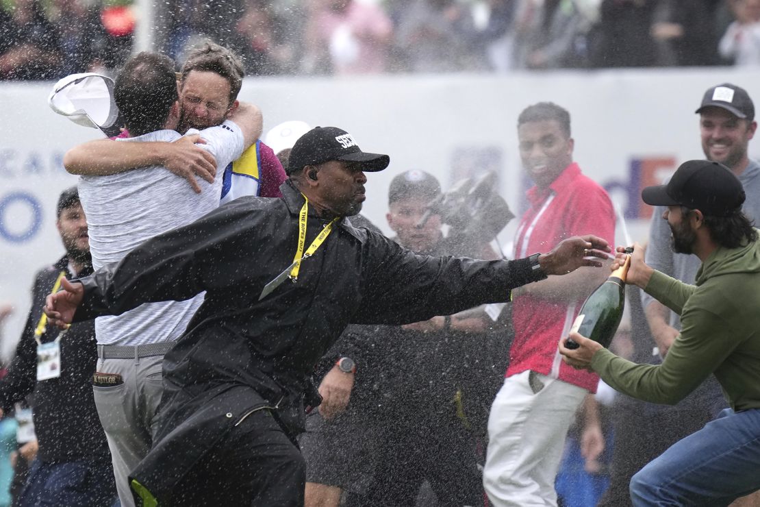 A security guard stops Hadwin as Taylor celebrates.