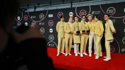 LOS ANGELES, CALIFORNIA - NOVEMBER 21: (L-R) V, Suga, Jin, Jungkook, RM, Jimin, and J-Hope of BTS, winners of the Favorite Pop Song, Favorite Pop Duo or Group, and Artist of the Year awards, pose in the press room during the 2021 American Music Awards at Microsoft Theater on November 21, 2021 in Los Angeles, California. (Photo by Matt Winkelmeyer/Getty Images for MRC)