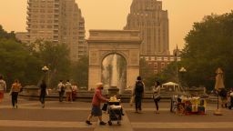 Pedestrians at Washington Square Park as smoke from Canada wildfires blankets New York, US, on Wednesday, June 7, 2023. The US Northeast, including New York City, will continue to breathe in choking smoke from fires across eastern Canada for the next few days, raising health alarms across impacted areas. Photographer: Alex Kent/Bloomberg via Getty Images