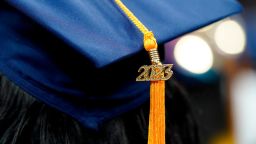 FILE - A tassel with 2023 on it rests on a graduation cap as students walk in a procession for Howard University's commencement in Washington, Saturday, May 13, 2023. MBA grads say the investment in their degree was worth it, according to a 2022 survey  by the Graduate Management Admission Council, an association of graduate business schools.   (AP Photo/Alex Brandon, File)