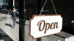 A store displays an 'open' sign along a street in Manhattan on February 14, 2023 in New York City. 