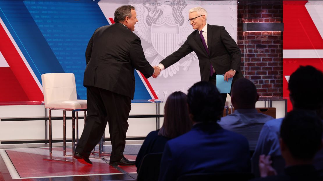 Former New Jersey Gov. Chris Christie greets CNN's Anderson Cooper at the start of the CNN Republican Presidential Town Hall in New York on Monday, June 12.