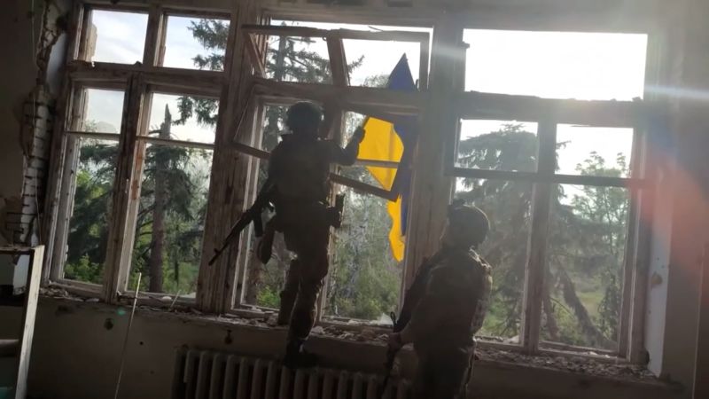 Ukrainian soldier raises flag in newly liberated village  | CNN