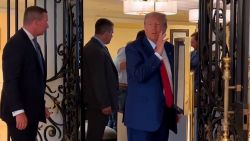 Former President Donald Trump greets people inside his resort in Doral, Florida, near Miami.