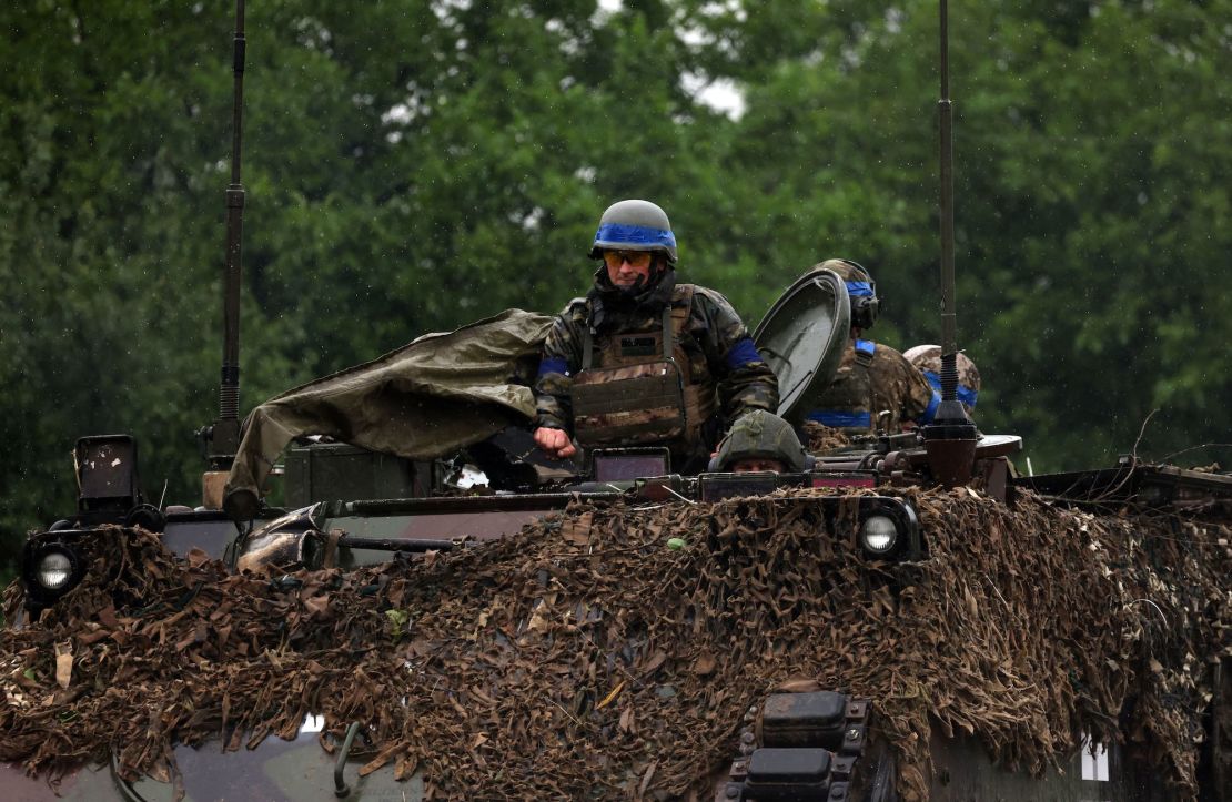Ukrainian troops ride atop an armored personnel carrier vehicle in the Zaporizhzhia region on June 11.