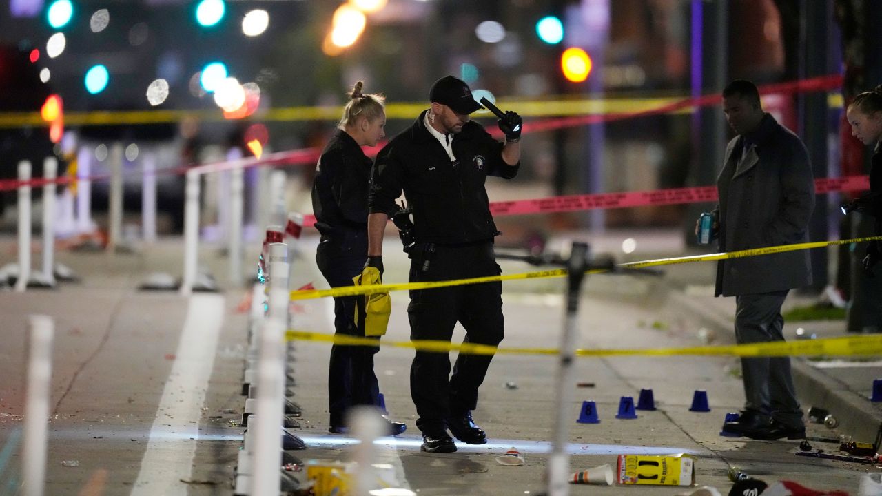 Investigators work at the scene of the mass shooting early Tuesday in Denver.