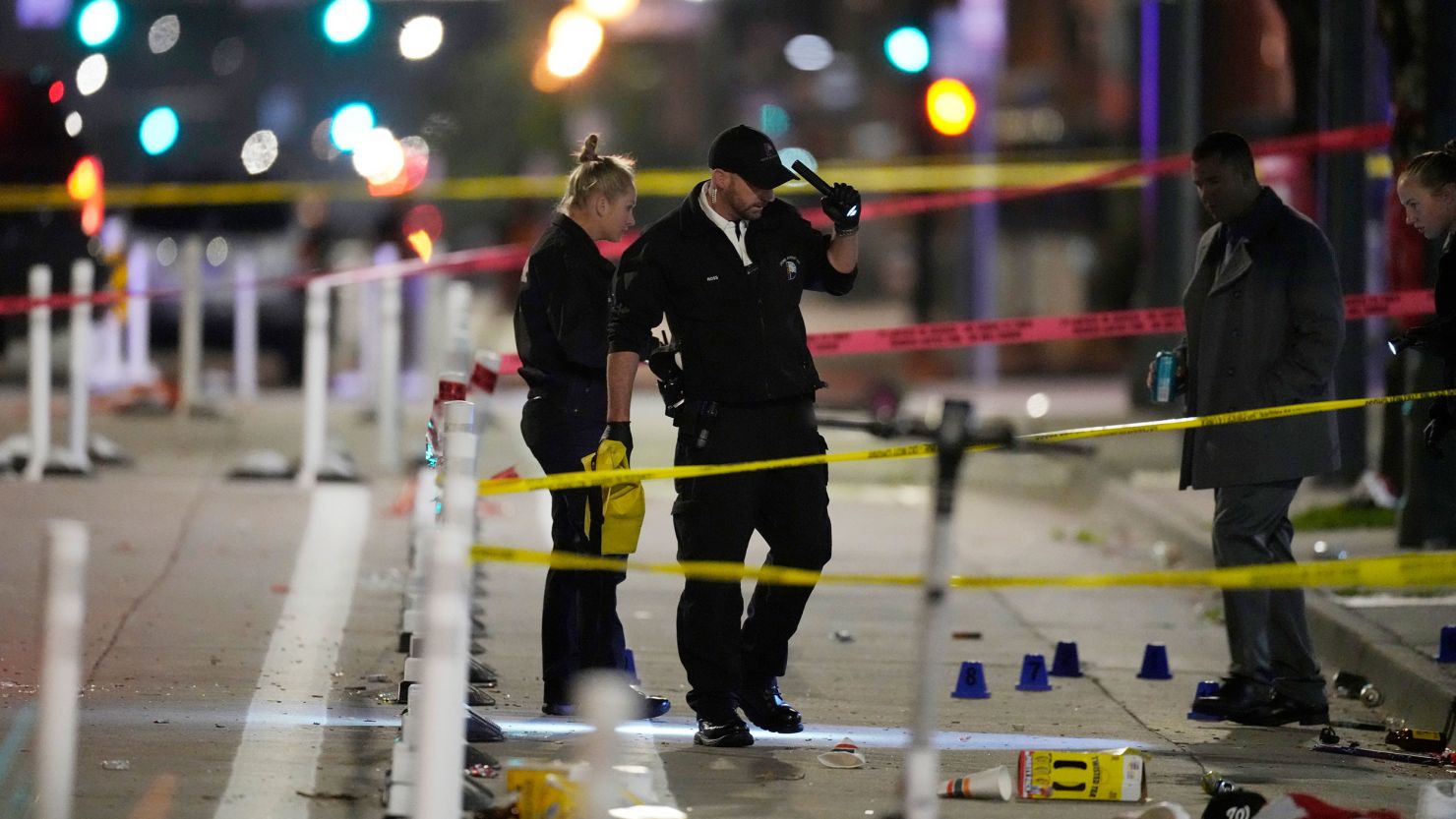 Investigators work at the scene of the mass shooting early Tuesday in Denver.