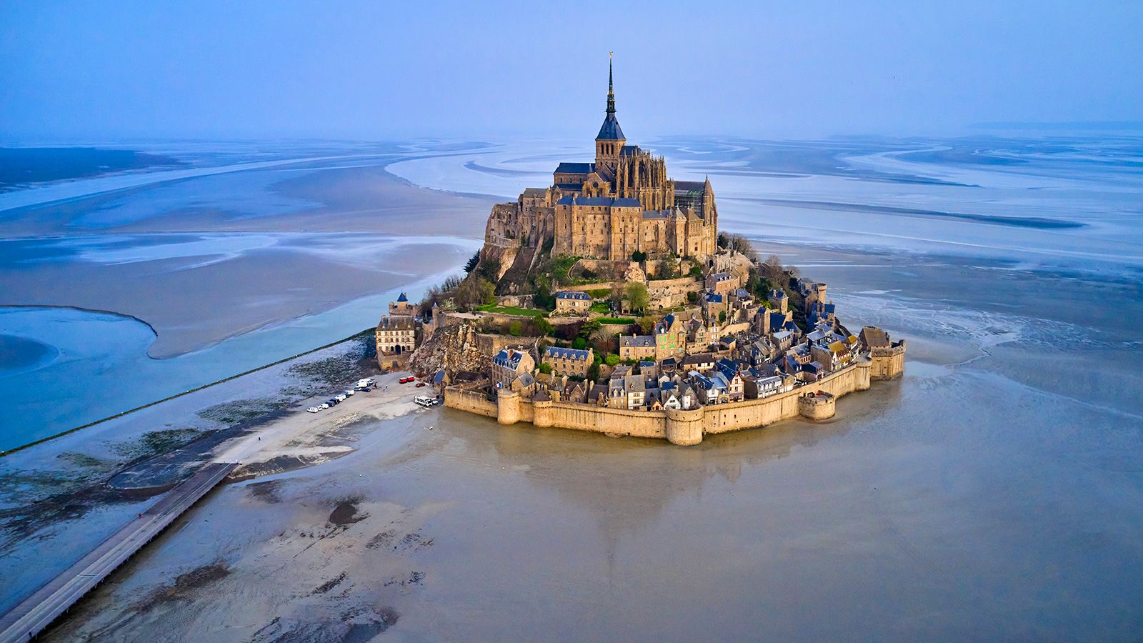 France, Normandy, Manche department, Bay of Mont Saint-Michel Unesco World Heritage, Abbey of Mont Saint-Michel during low tide, aerial view