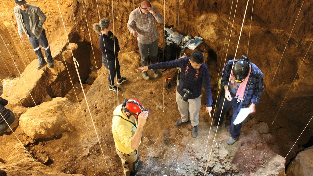 Archaeologists are shown here working at Tam Pa Ling cave in northeastern Laos.