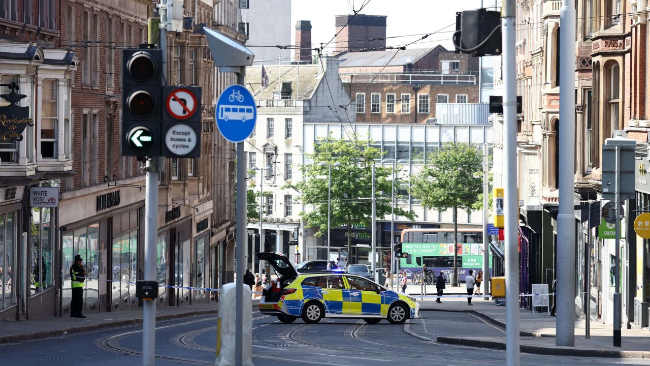 A police officer stands by a cordon on Market Street, after a string of incidents that left at least three people dead.